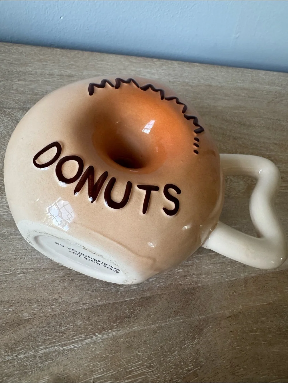 Donut-Shaped Ceramic Mug with Black Frosting and Tan Body